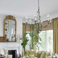 a living room with couches, chairs and a mirror on the wall above them