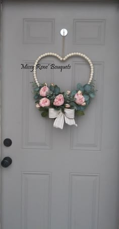 a heart shaped wreath hanging on the front door