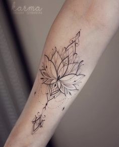 a woman's arm with a flower tattoo on it