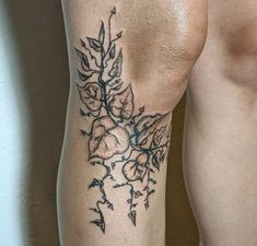 a close up of a person's leg with flowers on it