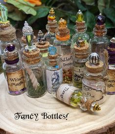 many small glass bottles with cork tops on a table