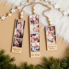 three pictures hanging from the side of a christmas tree next to pine branches and decorations