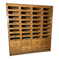 an old wooden filing cabinet with many drawers