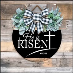 this is an image of a wreath with the words he is risen and a cross on it