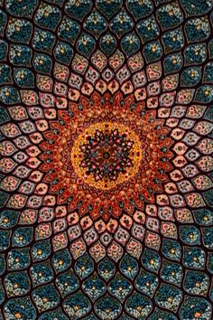 an intricate design is shown in the middle of this image, with many colors and shapes