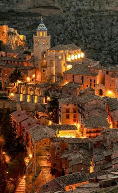 an old town lit up at night in the mountains