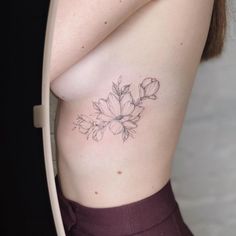 a woman with a flower tattoo on her stomach