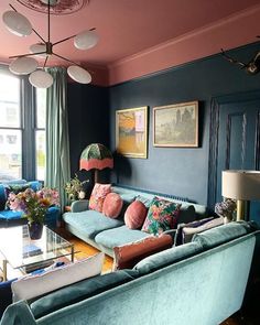 a living room filled with blue couches and colorful pillows