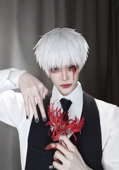 a man with white hair and red flowers in his hand, wearing a vest over a shirt