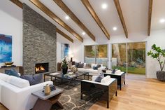 Beverly Hills ranch home living room with chic, warm interior design, stacked slate rustic modern fireplace & artworks. High Ceiling Living Room