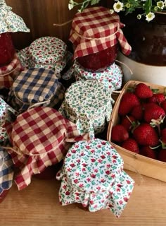 strawberries and other fruit are sitting on the table next to each other in baskets