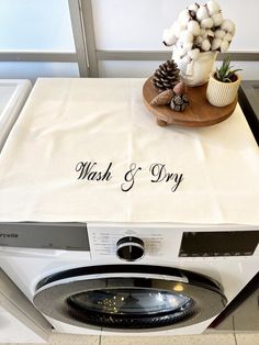 a washer and dryer sitting next to each other on top of a counter