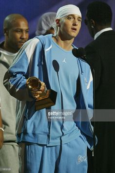 the rapper holding his award for best rapp album