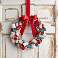 a red ribbon hanging on a door with spools of thread