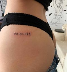 a woman's stomach with the word princess tattooed on her lower back and side