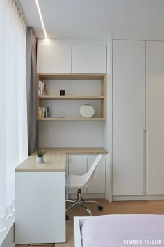 a bedroom with a bed, desk and bookcases in white wood paneling