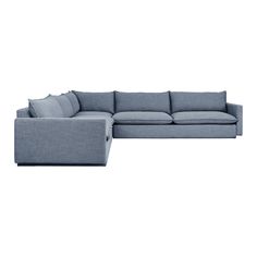 a blue sectional couch sitting on top of a white floor