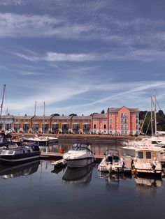 several boats are docked in the water near buildings