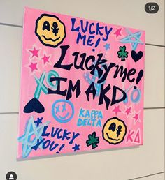 a pink sign with lots of stickers on it that says lucky me, lucky me, i'm ard