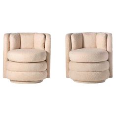 a pair of swivel chairs made out of wool