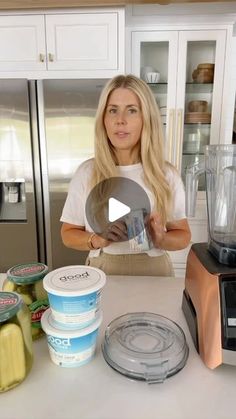 a woman standing in front of a kitchen counter with ice cream and yogurt