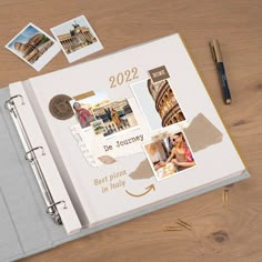 an open planner book on a wooden table with some photos and pencils next to it