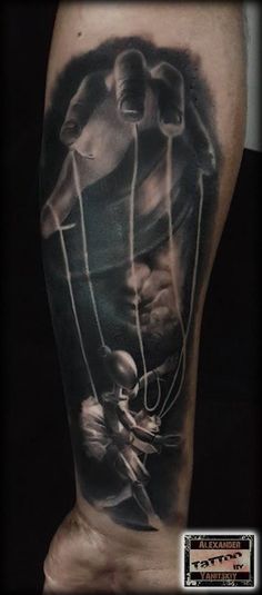 a black and white photo of a man's leg with an abstract tattoo on it