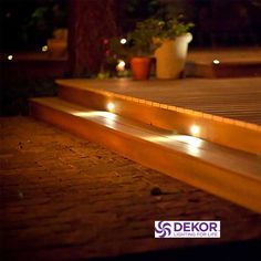 some lights that are on the side of a wooden bench