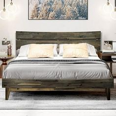 a large bed sitting in a bedroom next to two nightstands and a painting on the wall