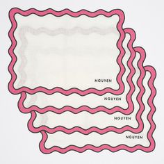 three pink scalloped placemats sitting on top of each other