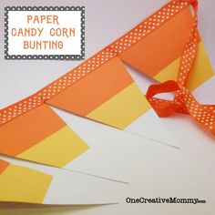 an orange and yellow ribbon is on top of a white card with the words paper candy corn bunting