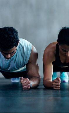 two people are doing push ups on the floor