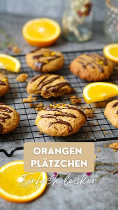 orange and chocolate cookies on a cooling rack with the words orange platzchen