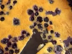 a blueberry pie is shown with a knife in it's crust and has been cut into pieces