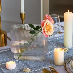 the table is set with candles and plates