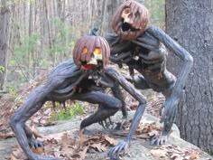 two creepy looking halloween decorations in the woods