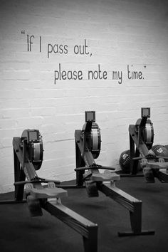 three machines sitting in front of a white brick wall with a quote written on it