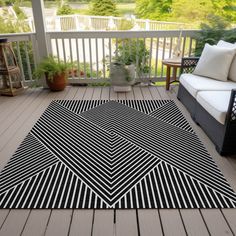 a black and white area rug on a deck