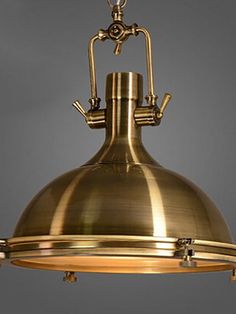 an antique brass pendant light fixture hanging from the ceiling