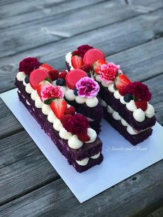 there is a piece of cake that has flowers on the top and berries on the bottom