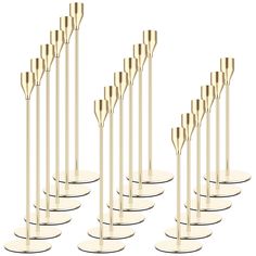 a set of eight brass candlesticks on white bases