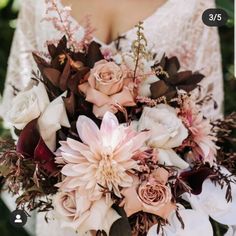 a woman holding a bouquet of flowers in her hands