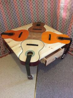 a wooden table with guitars on it