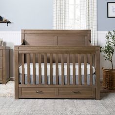 a baby crib in a room with blue walls and white carpeted flooring