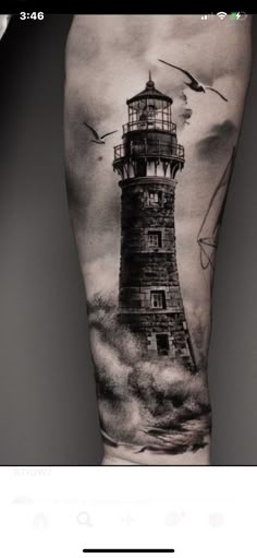 a man's leg with a lighthouse tattoo on it