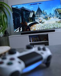 a video game controller sitting in front of a tv