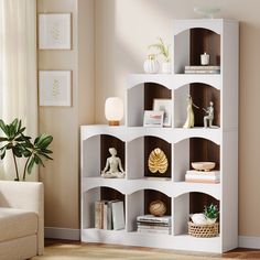 a living room filled with furniture and a white book shelf next to a couch in front of a window