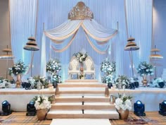 a decorated stage with blue and white flowers