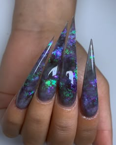 Dark Opal – Multicolor Iridescent Nail Look into my crystal ball! This set radiates the dreamiest opals from loose iridescent flakes and custom mixed acrylic colors. Dark Opal features multi-layered caverns of lilac and green flash that will hypnotize you! Choose your preferred nail shape and length! Designed by Keara (@thenailvibes). Order Details Made to order! 7-28 day lead time. Upon purchase, we will reach out to you for a personalized design consultation! This design is a preset. If you wa Lilac And Green, Acrylic Nails Stiletto, Opal Nails, Encapsulated Nails, Galaxy Nails, Nail Design Inspiration, Stiletto Nails Designs, Vibrant Nails, Dope Nail Designs