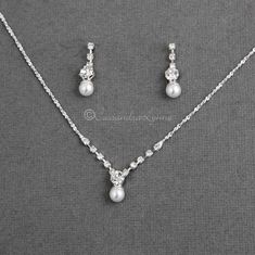 a necklace and earring set with pearls